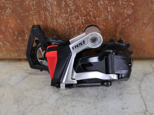 Schaltungsteile von Sram, SRAM RED ETAP AXS SCHALTWERK E1 / 12 - FACH – MAX. 36T – WIRELESS vor USEDBIKES - OB.DE Hintergrund