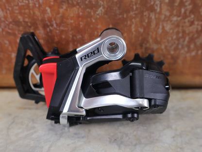 Schaltungsteile von Sram, SRAM RED ETAP AXS SCHALTWERK E1 / 12 - FACH – MAX. 36T – WIRELESS vor USEDBIKES - OB.DE Hintergrund