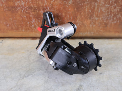 Schaltungsteile von Sram, SRAM RED ETAP AXS SCHALTWERK E1 / 12 - FACH – MAX. 36T – WIRELESS vor USEDBIKES - OB.DE Hintergrund