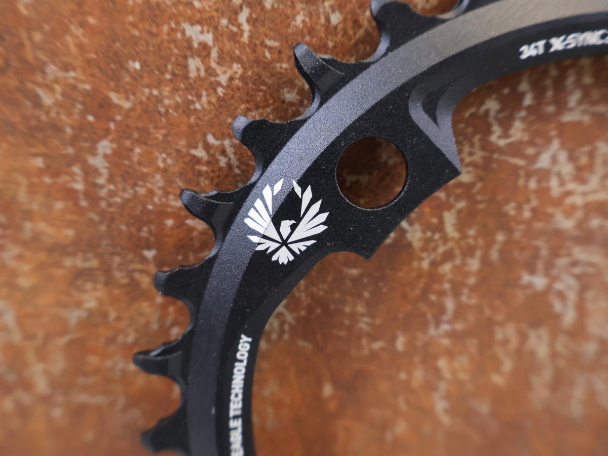 Kettenblatt von Sram, SRAM X-SYNC 2 EAGLE KETTENBLATT 34T 104 MM BCD vor USEDBIKES-OB.DE Hintergrund
