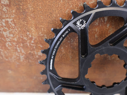 Kettenblatt von Sram, SRAM X SYNC 2 KETTENBLATT 6 MM OFFSET 34T / 36T / 3 BOLT vor USEDBIKES-OB.DE Hintergrund