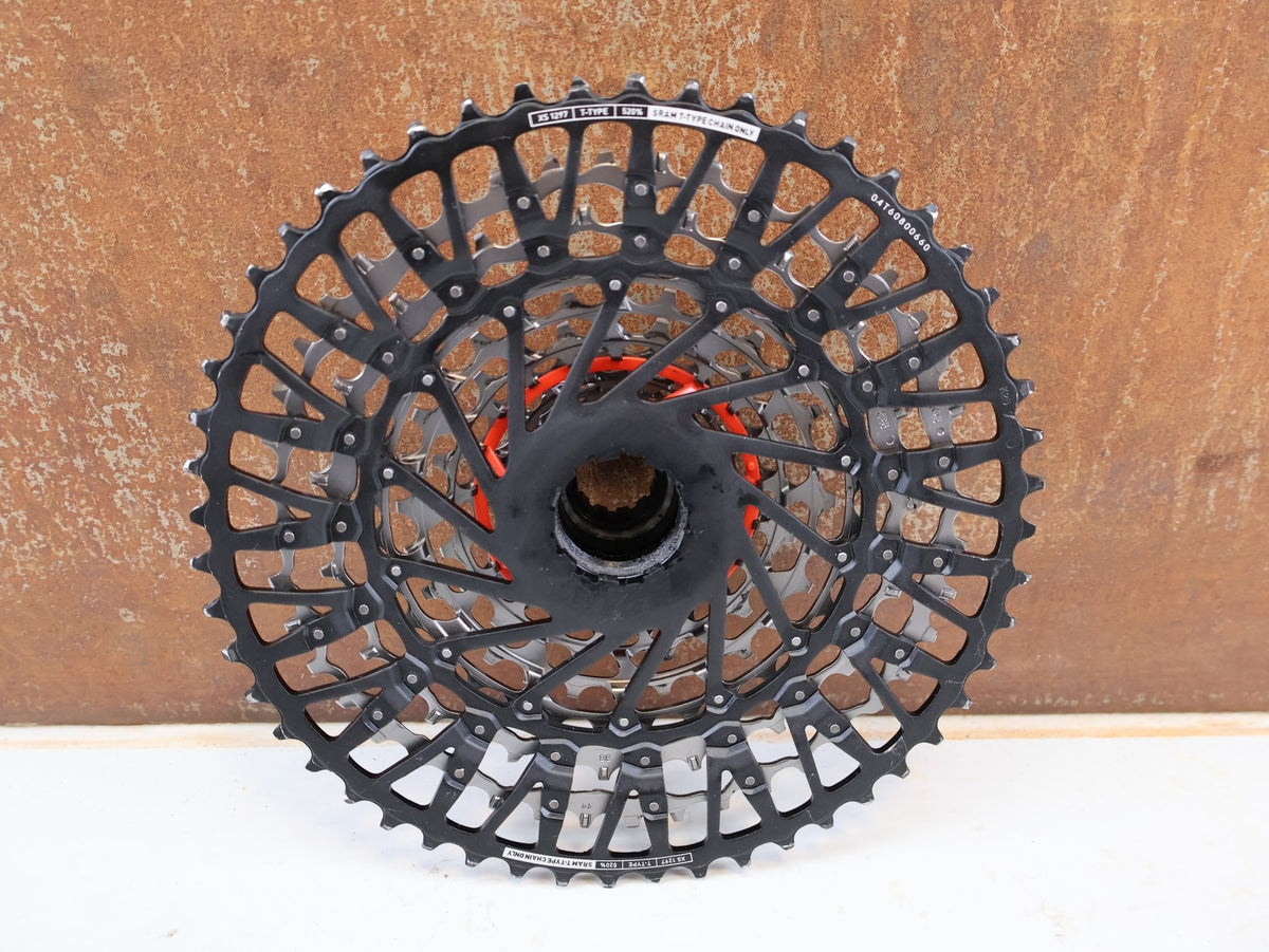 Kassette & Zahnkränze von Sram, SRAM XX Eagle XS-1297 T-Type Kassette 12-fach 10-52T Silber vor USEDBIKES-OB.DE Hintergrund