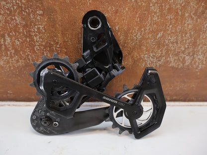 Schaltungsteile von Sram, SRAM XX SL EAGLE AXS T-TYPE SCHALTWERK / 12-FACH TRANSMISSION CARBON MTB vor USEDBIKES-OB.DE Hintergrund