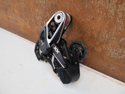 Schaltungsteile von Sram, SRAM XX SL EAGLE AXS T-TYPE SCHALTWERK / 12-FACH TRANSMISSION CARBON MTB vor USEDBIKES-OB.DE Hintergrund