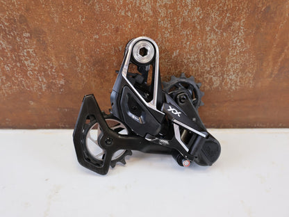 Schaltungsteile von Sram, SRAM XX SL EAGLE AXS T TYPE SCHALTWERK 12 FACH TRANSMISSION vor USEDBIKES-OB.DE Hintergrund