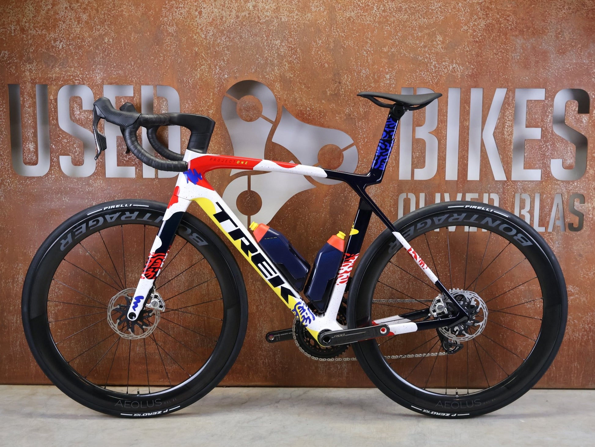 Rennrad von Trek, TREK MADONE SLR 9 AXS GEN 8 ICON COULER CARBON RENNRAD – M/L vor USEDBIKES - OB.DE Hintergrund