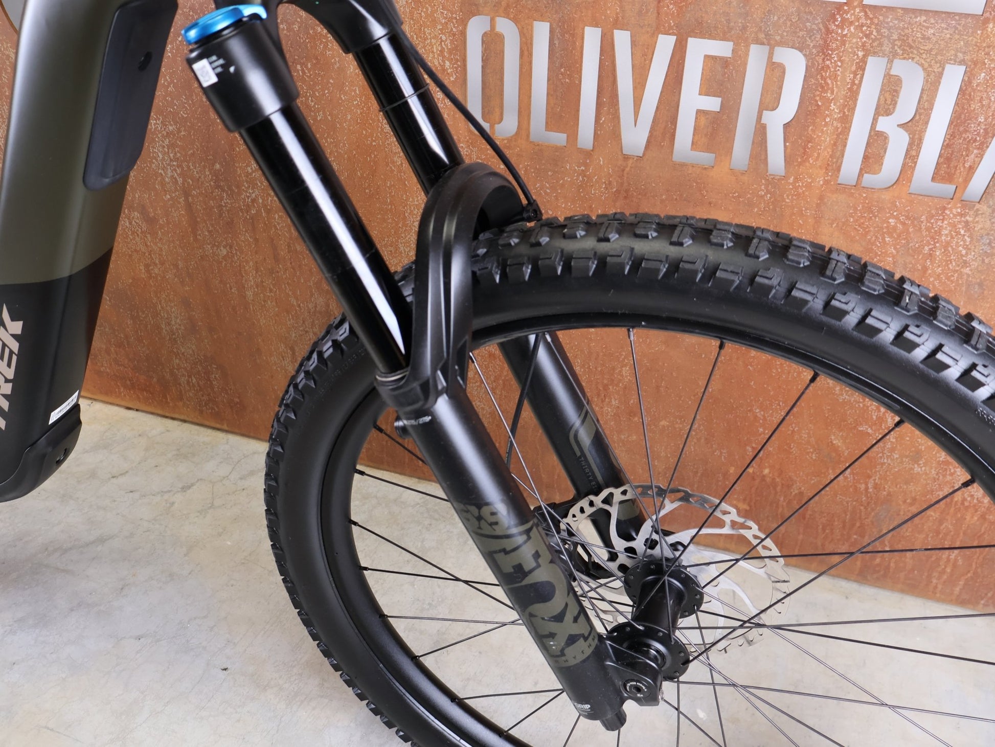 E - Mountainbike von Trek, TREK SLASH+ 9.7 SLX/XT / OLIVE DRAB / S vor USEDBIKES - OB.DE Hintergrund