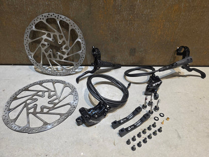 Bremse von TRP, TRP TRAIL EVO HD - M843 SCHEIBENBREMSE 203MM VORNE UND HINTEN vor USEDBIKES - OB.DE Hintergrund